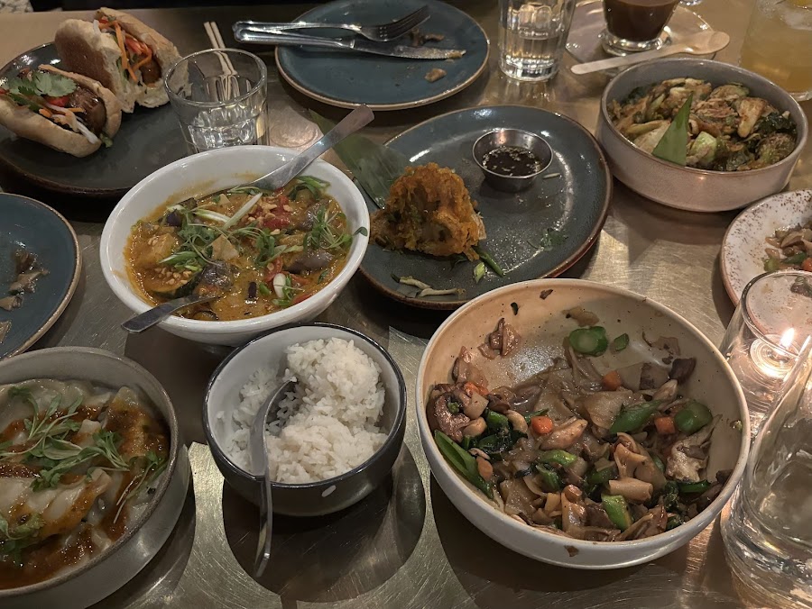 A dim Southeast Asian dining room with a bar