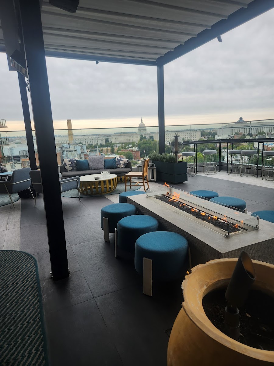 A craft cocktail on a rooftop bar at dusk