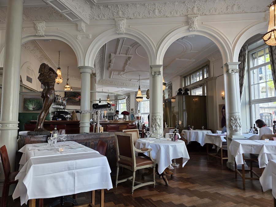 Ornate ceiling and chandeliers at a Zurich Italian restaurant