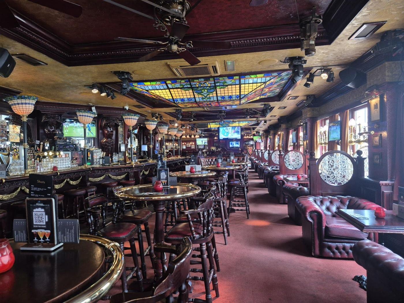Traditional Irish pub interior with sports screens in Amsterdam