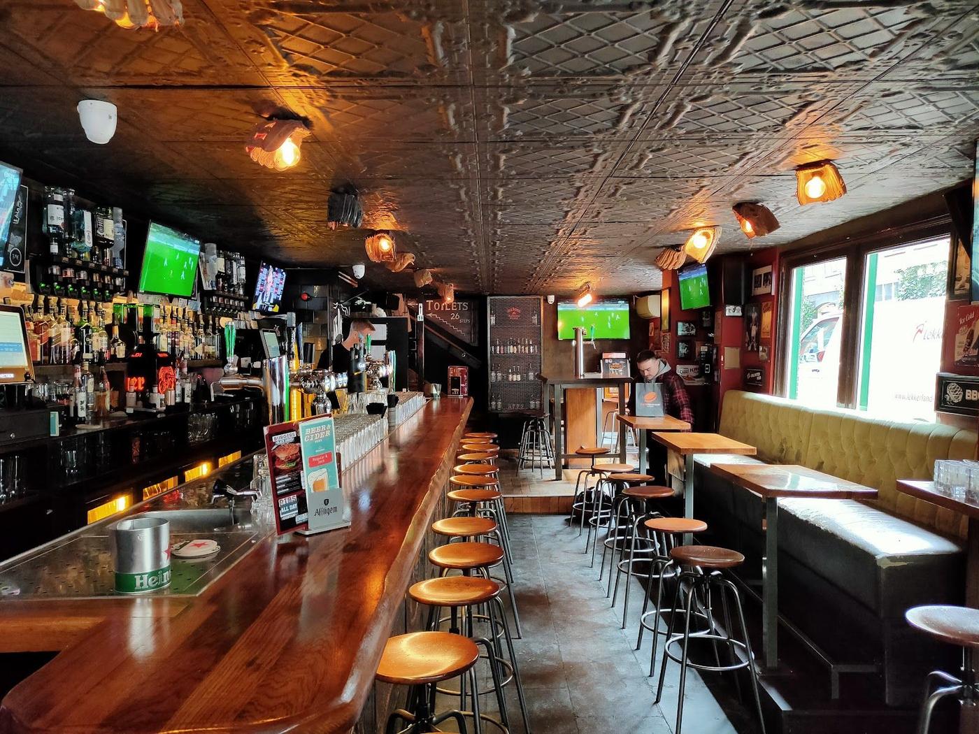 Traditional English pub interior showing live football in Amsterdam