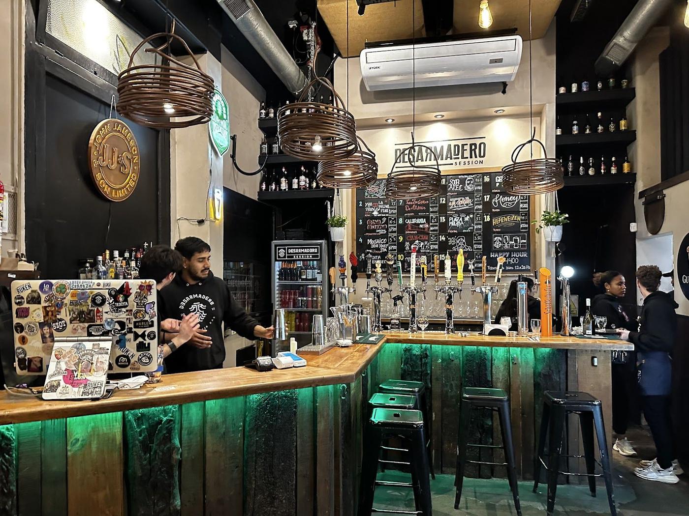 Glasses of amber beer on a wooden bar counter