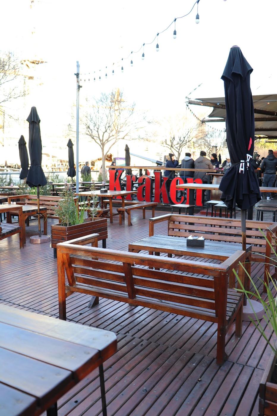 Corner bar with outdoor tables lit up at night