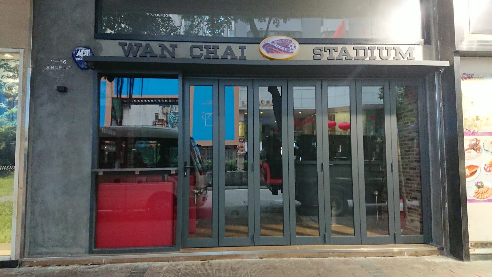 Sports bar interior Hong Kong with screens and crowd