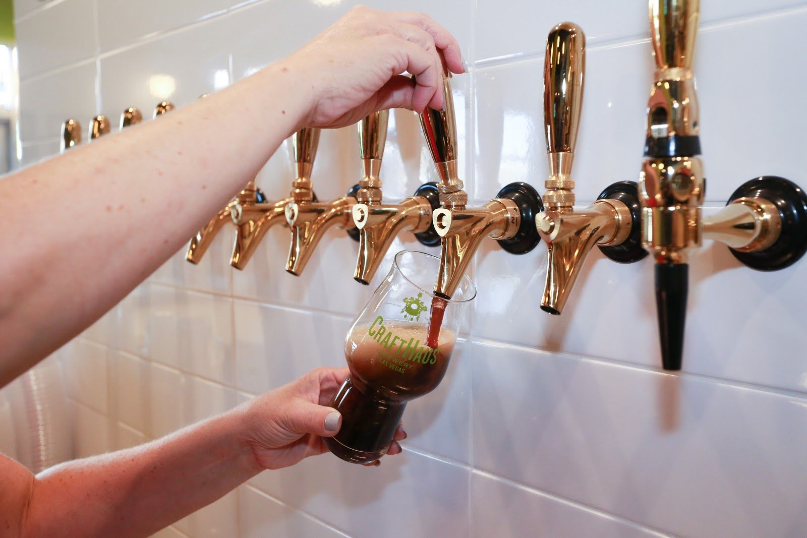 Rows of beer taps along a bar counter