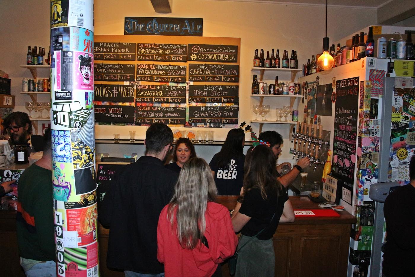 People drinking outside a bar at night