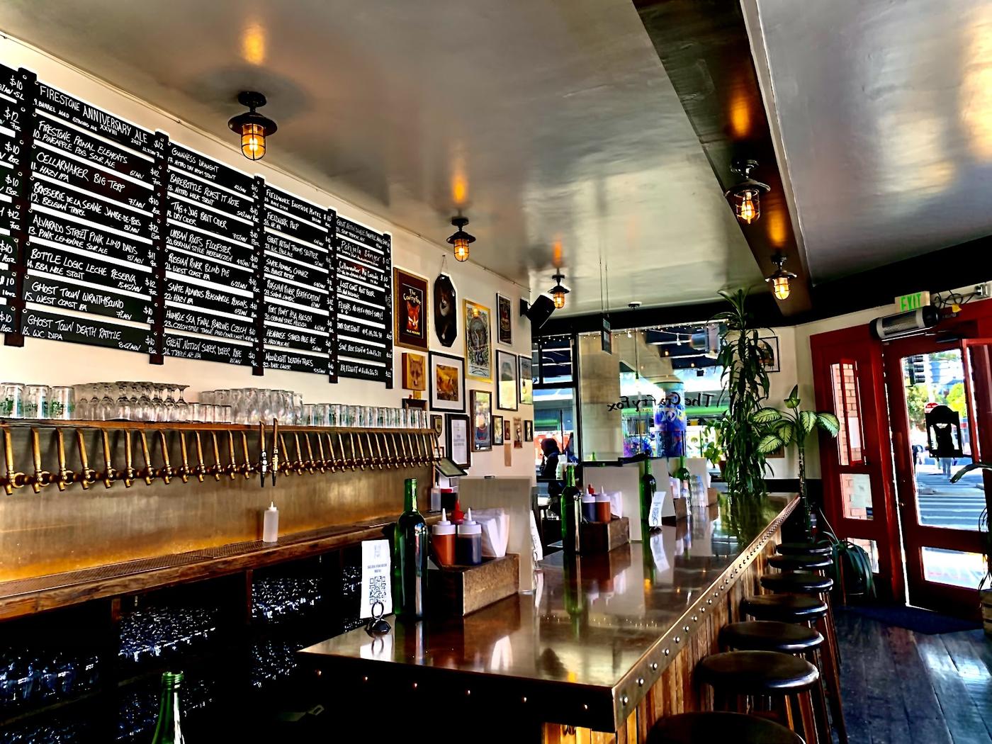 Bartender pouring amber beer from a taproom tap