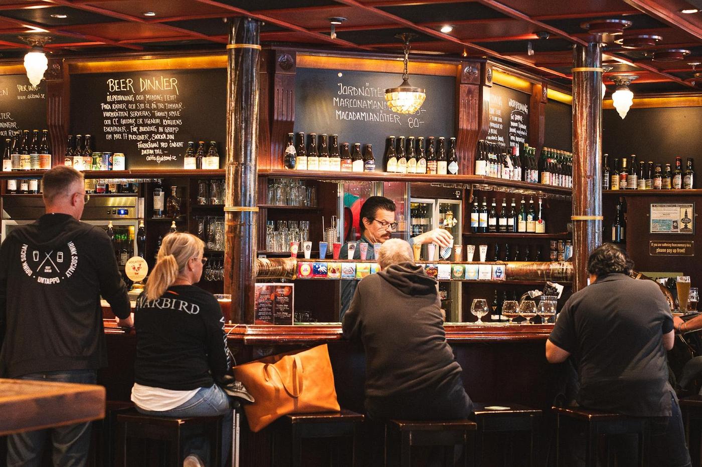 Glasses of beer on a wooden bar counter